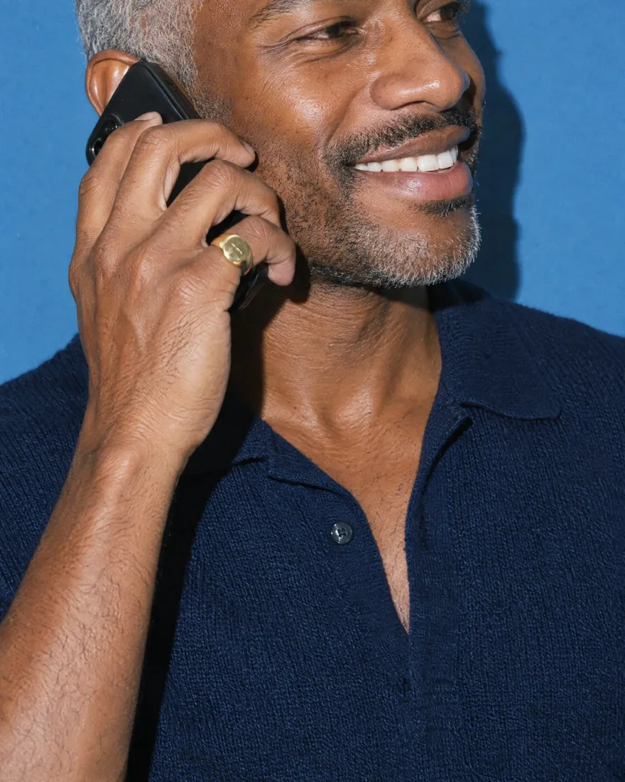 A man on a phone call, smiling