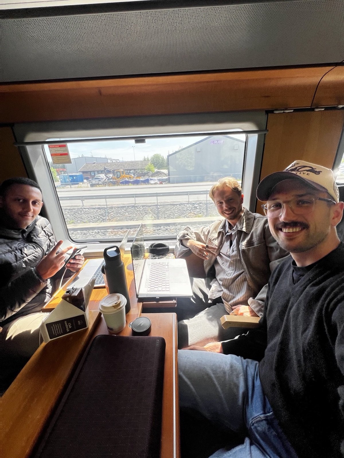 The three Jenz founders working on a train