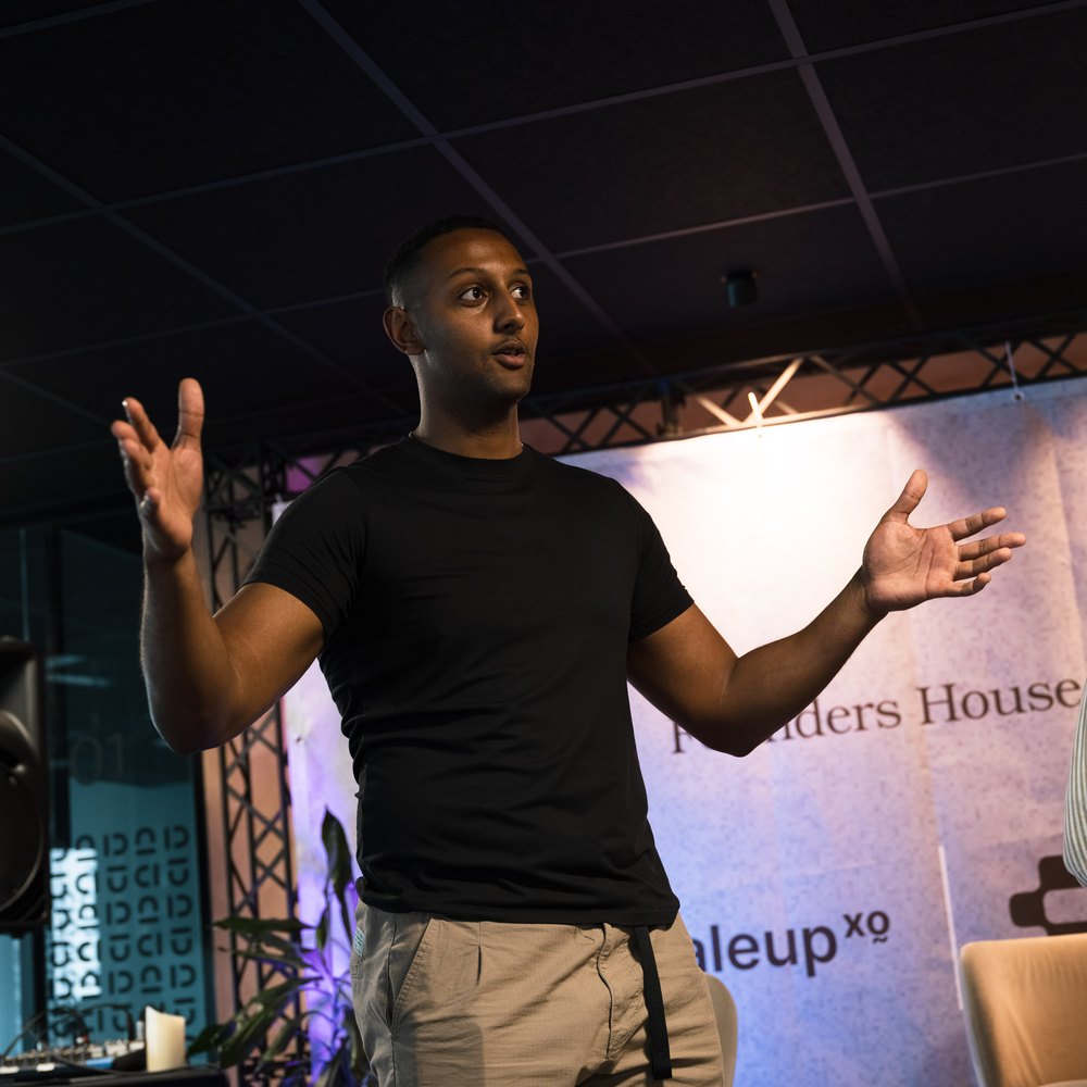 Natnael speaking on stage